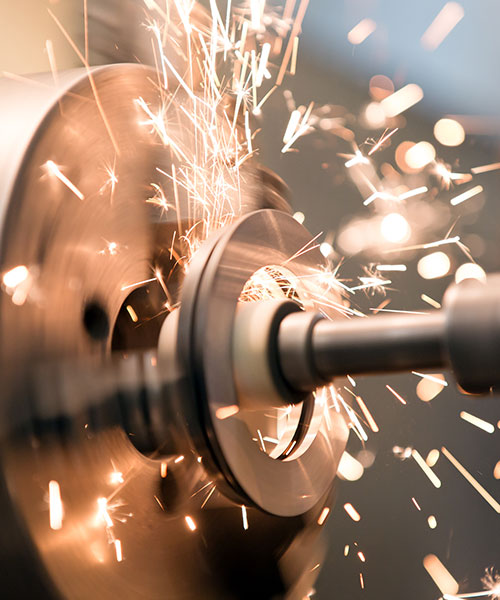 Sparks flying from machinery to represent the manufacturing industry