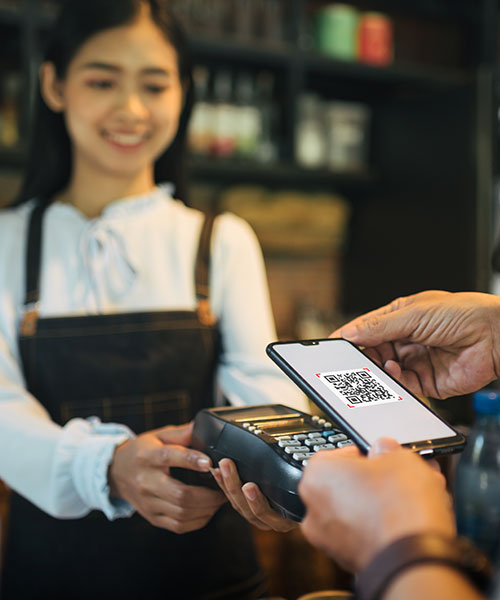 Cashier at retail store accepting digital payment